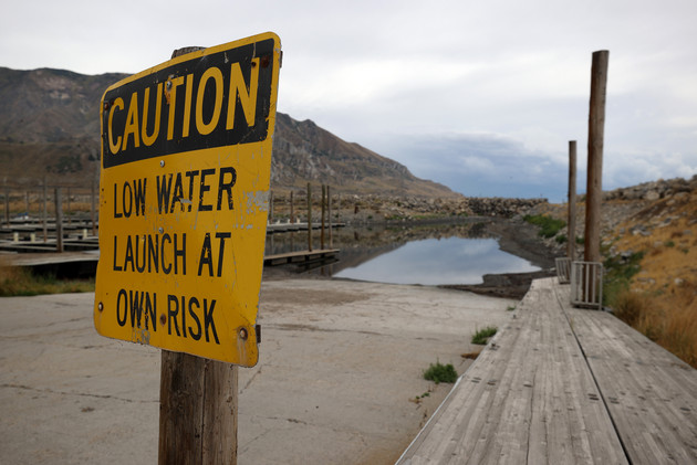 A sign warning of low water levels is posted near a boat launch ramp to the Great Salt Lake.
