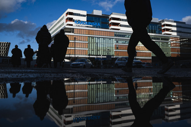 People walk by the Karolinska University Hospital in Solna, near Stockholm. 