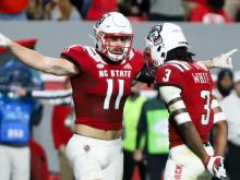 Payton Wilson (11)  and Aydan White (3) celebrate after a big play on defense. No. 14 NC State held on to beat Florida State by a score of 19-17 in Raleigh, North Carolina on October 8, 2022. (Jerome Carpenter/WRAL Contributor)