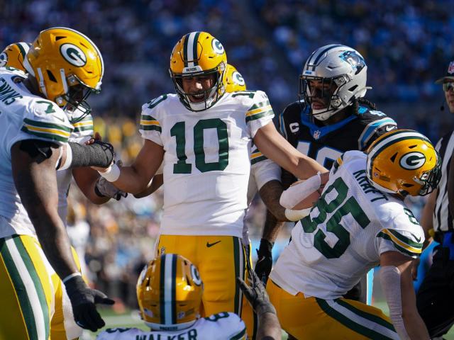 The Green Bay Packers, led by Jordan Love, hang on against the Carolina Panthers in a 33-30 victory, keeping their chances at the playoffs alive.