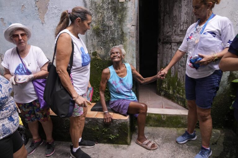 Health workers in Brazil are searching through junkyards and on rooftops to find mosquitos in order to combat the dengue outbreak.