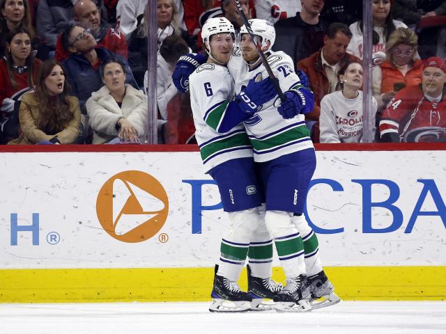 Lindholm nets a pair in first game with Canucks to secure 3-2 victory against Hurricanes on WRALSportsFan.com.