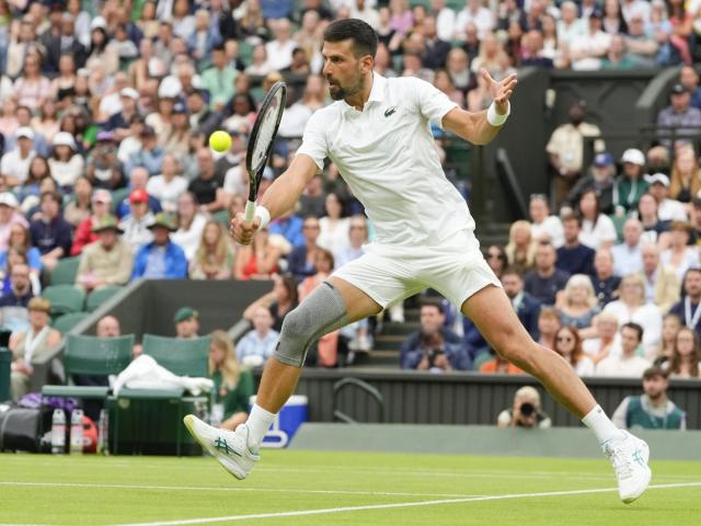 Novak Djokovic wins his first match at Wimbledon with a sleeve on his surgically repaired knee :: WRALSportsFan.com