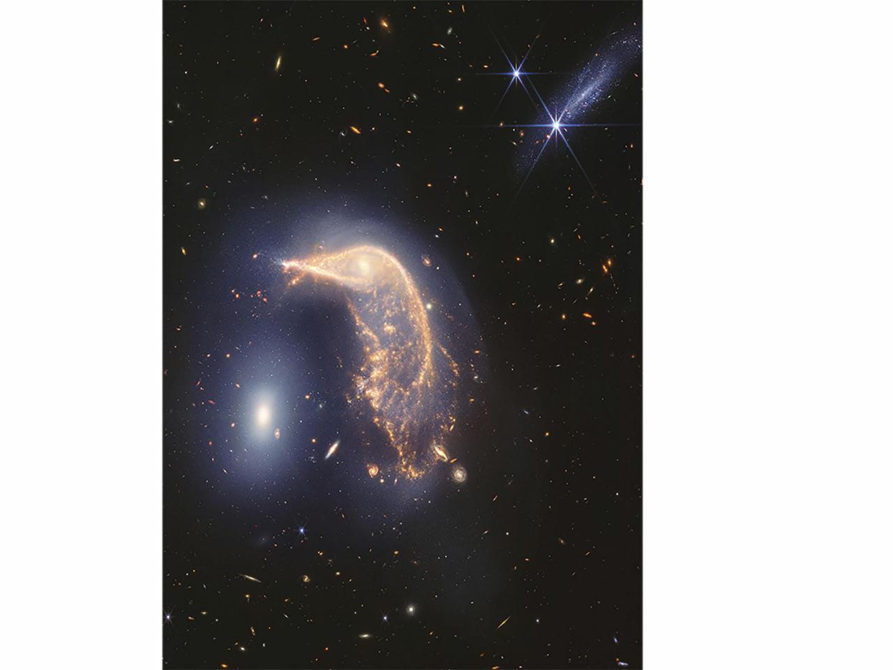 Webb Space Telescope's latest cosmic shot shows pair of intertwined galaxies glowing in infrared