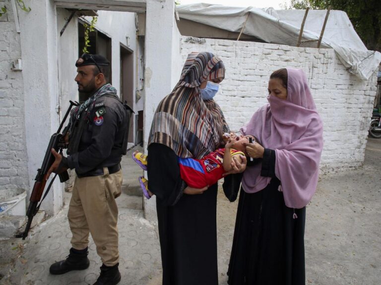 A bomb hits a vehicle guarding an anti-polio drive in Pakistan and wounds 9