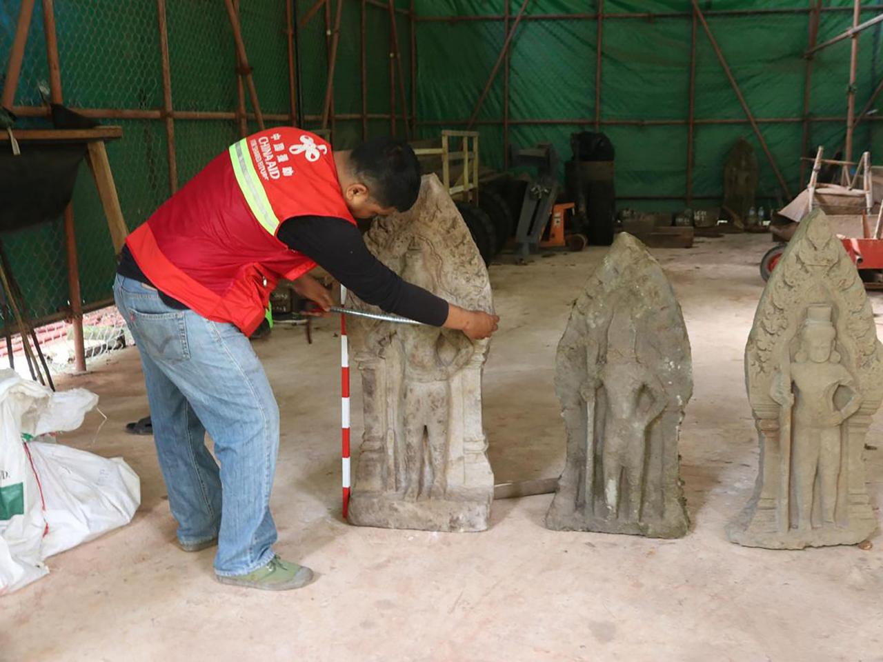 Cambodian archaeologists discover a dozen centuries-old sandstone statues at Angkor UNESCO site