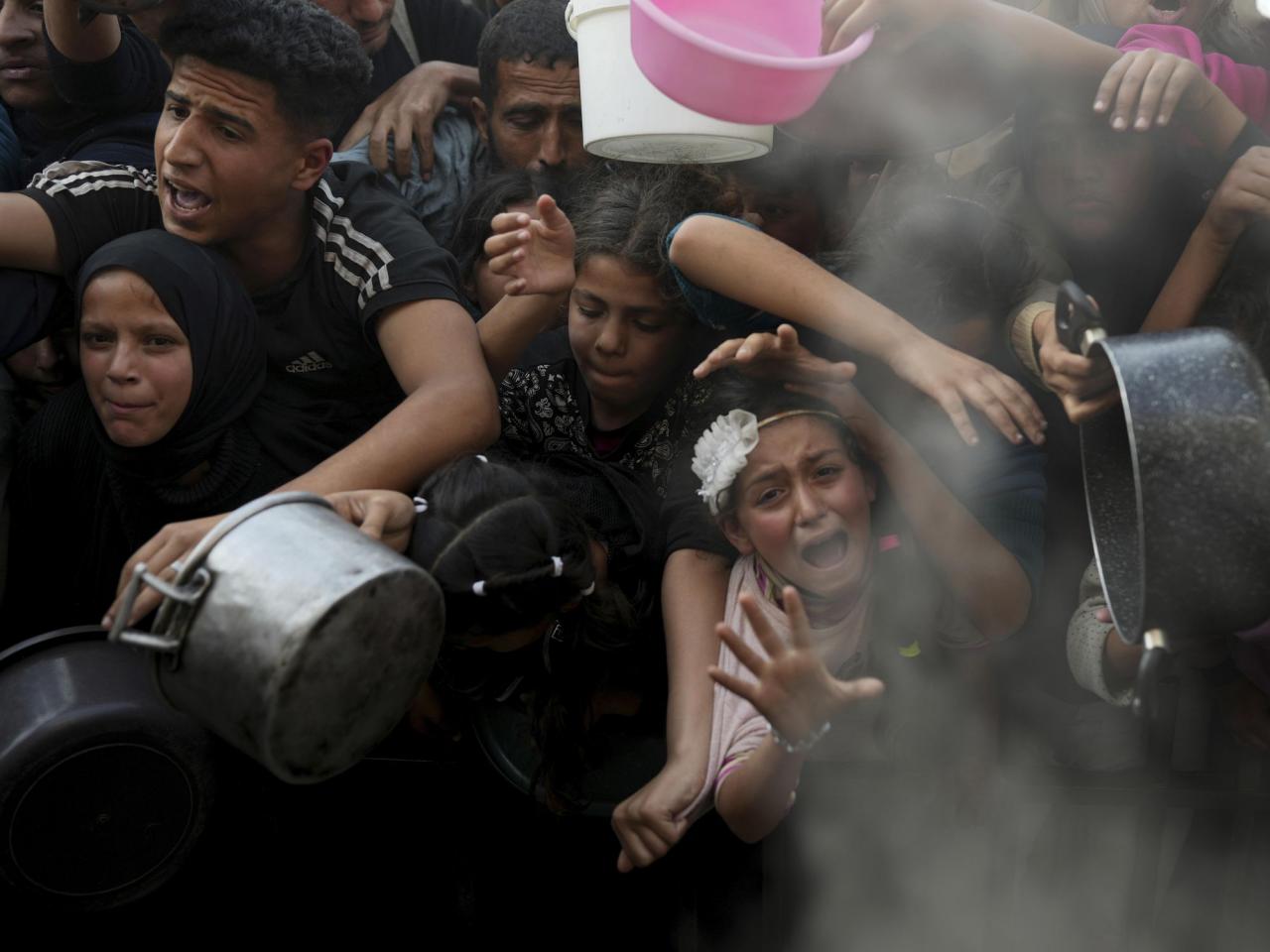 Desperate children and adults in Gaza struggle to get food as Israel blocks aid